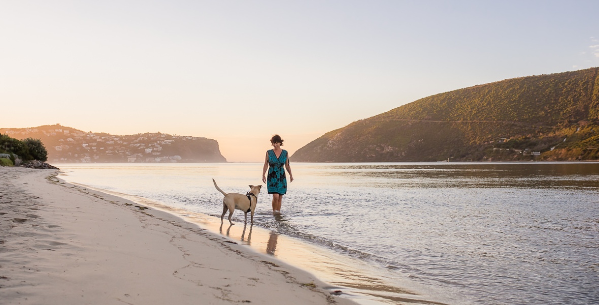 woman playing with dog on Leisure Island Beach during personal branding session photographed by moira du toit of moi du toi photography